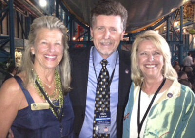 With the late Alan Shepard's daughters, Laura and Julie, at Apollo 16's 40th anniversary event in April 2012 at Kennedy Space Center. Standing under one of only three remaining 363 ft. Saturn V rockets, steps away from Shepard's Apollo 14 command module. He was the first American to fly in space.