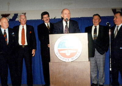 Emceeing the San Diego Aerospace Museum 2001 Benefit Gala. Left to right: NASA's Gene Krantz, Eugene Cernan (last man to walk on the moon), Alexei Leonov (first man to walk in space), Larson (periodically spacey), Thomas Stafford, Valeriy Kubasov and Wally Schirra. The event marked the 25th anniversary of the Apollo-Soyuz project and reunited several astronauts.