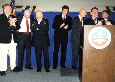 Emceeing the San Diego Aerospace Museum 2001 Benefit Gala. Left to right: NASA's Gene Krantz, Eugene Cernan (last man to walk on the moon), Alexei Leonov (first man to walk in space), Larson (periodically spacey), Thomas Stafford, Valeriy Kubasov and Wally Schirra. The event marked the 25th anniversary of the Apollo-Soyuz project and reunited several astronauts.